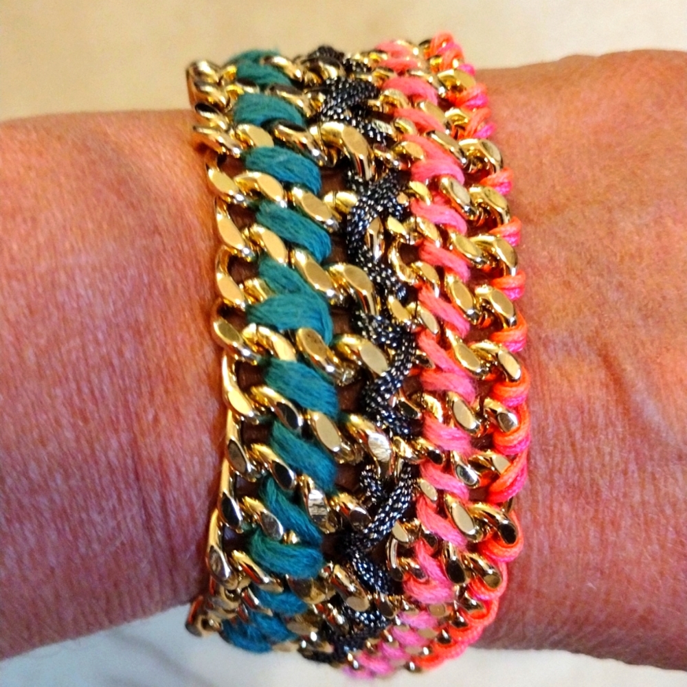 Beautiful multiple chain bracelet with braided color twine dangling charm.